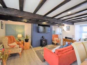 a living room with orange furniture and a tv at 2 Bed in Kirkby Thore oc-78744 in Kirkby Thore +7 photos