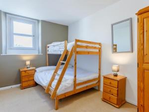 a bedroom with two bunk beds and two windows at 2 Bed in Kirkby Thore oc-78744 in Kirkby Thore