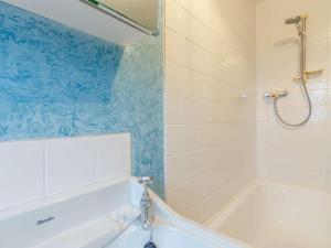 a bathroom with a white tub and a shower at 2 Bed in Anstruther oc-ca006 in Crail +9 photos