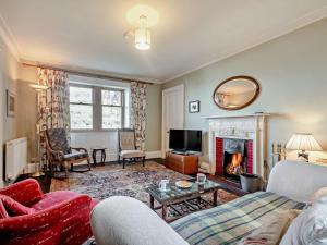 a living room with a couch and a fireplace at 2 Bed in Isle Of Arran oc-77882 in Lochranza