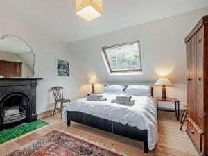 a bedroom with a bed and a fireplace at 2 Bed in Isle Of Arran oc-77882 in Lochranza