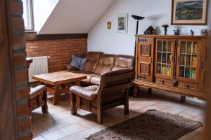 a living room with a couch and a table at Penzion Novopacké Sklepy in Nová Paka