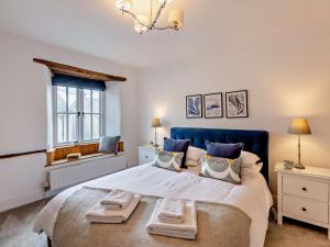 a bedroom with a large bed with towels on it at 3 Bed in Grange-over-sands oc-95100 in Cark