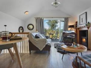 a living room with a couch and a table at 1 Bed in Coniston oc-lcc37 in High Nibthwaite +16 photos