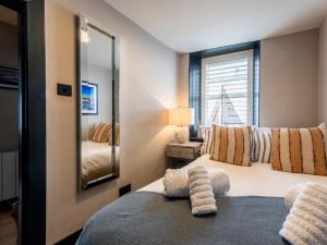 a bedroom with two beds and a large mirror at 3 Bed in Stranraer oc-77308 in Portpatrick