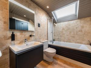 a bathroom with a tub and a toilet and a sink at 3 Bed in Stranraer oc-77308 in Portpatrick +24 photos