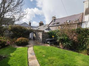 a garden with a bench in front of a house at 3 Bed in Stranraer oc-77308 in Portpatrick