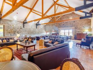 a large living room with couches and tables at 8 Bed in Kirriemuir oc-ca261 in Kirriemuir
