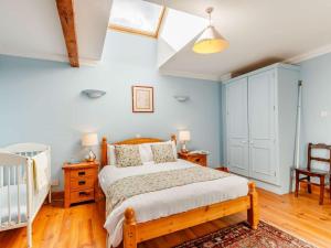 a bedroom with a bed and a crib at 8 Bed in Kirriemuir oc-ca261 in Kirriemuir