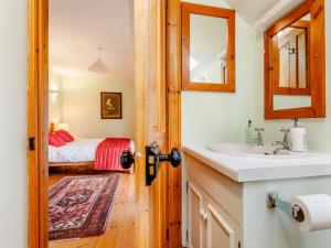 a bathroom with a sink and a mirror and a bed at 8 Bed in Kirriemuir oc-ca261 in Kirriemuir +23 photos