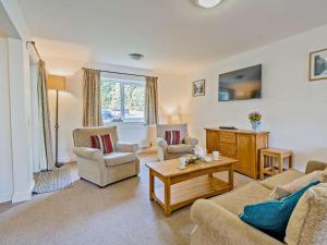 a living room with couches and chairs and a table at 3 Bed in Penrith oc-85896 in Penruddock