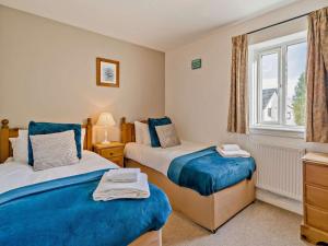 a bedroom with two beds and a window at 3 Bed in Penrith oc-85896 in Penruddock +25 photos