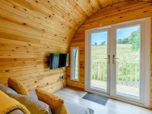 a living room with a large window and a tv at 1 Bed in Coniston oc-88961 in Coniston