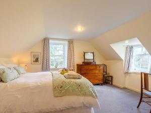 a bedroom with a bed and a dresser with a television at 4 Bed in Ayr- oc-90038 in Ayr