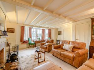 a living room with a couch and a table at 4 Bed in Ayr- oc-90038 in Ayr