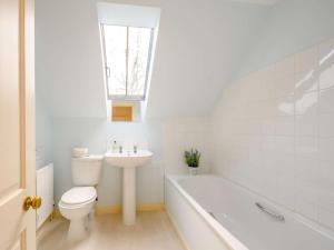 a bathroom with a toilet and a sink and a bath tub at 4 Bed in Ayr- oc-90038 in Ayr +11 photos