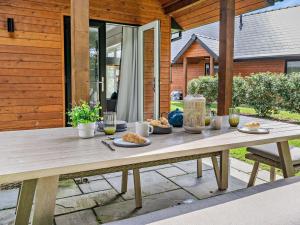a wooden table with food on it on a patio at 2 Bed in Swansea oc-91724 in Killay