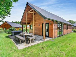 a wooden house with a picnic table and a grill at 2 Bed in Swansea oc-91724 in Killay