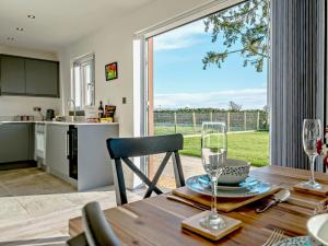 a kitchen and a dining room with a table and a window at 4 Bed in Penrith oc-89353 in Little Salkeld