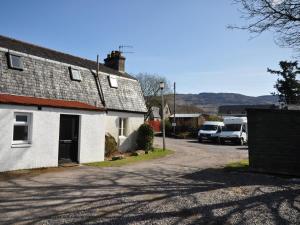 a white house with cars parked in a parking lot at 2 Bed in Fort Augustus oc-in637 in Fort Augustus +5 photos