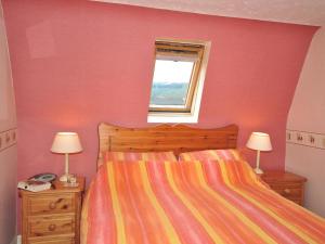 a bedroom with a bed and two lamps and a window at 2 Bed in Fort Augustus oc-in637 in Fort Augustus
