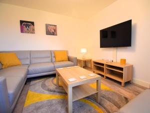 a living room with a couch and a flat screen tv at 4 Bed in Penrith oc-89353 in Little Salkeld