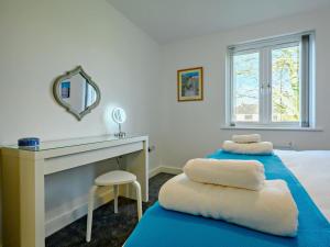 a bedroom with two beds and a desk and a mirror at 4 Bed in Penrith oc-89353 in Little Salkeld +36 photos