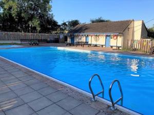 a swimming pool with blue water in a yard at 4 Bed in Penrith oc-89353 in Little Salkeld