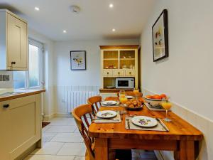 a kitchen with a wooden table with food on it at 2 Bed in Ludlow oc-91422 in Ludlow +20 photos