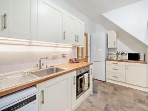 a kitchen with white cabinets and a sink at 2 Bed in Morecambe oc-93719 in Heysham
