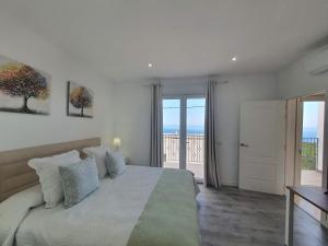 a bedroom with a bed with a view of the ocean at Casa Sandra in Tazacorte +32 photos