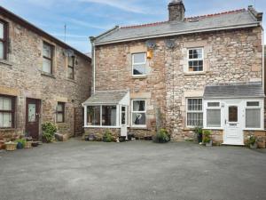 an old brick house with a parking lot in front of it at 2 Bed in Morecambe oc-93719 in Heysham
