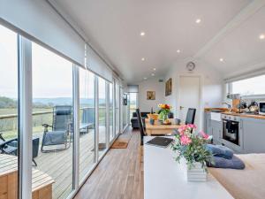 a kitchen and living room with sliding glass doors at 1 Bed in Dalry oc-91418 in Dalry