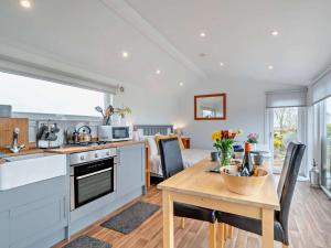 a kitchen and dining room with a table and a kitchen and a living room at 1 Bed in Dalry oc-91418 in Dalry +6 photos