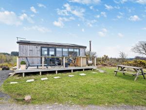 a tiny house sitting on top of a lush green field at 1 Bed in Dalry oc-91418 in Dalry