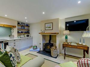 a living room with a couch and a fireplace at 1 Bed in Hawick oc-91437 in Denholm
