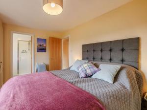 a bedroom with a large bed with two pillows at 1 Bed in Northwich oc-91266 in Whitegate
