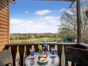 a table on a balcony with a view of a field at 1 Bed in Northwich oc-91266 in Whitegate