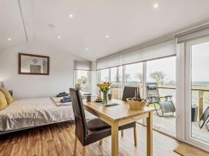 a bedroom with a bed and a desk with a table at 1 Bed in Dalry oc-91417 in Dalry