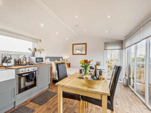 a kitchen and living room with a table and chairs at 1 Bed in Dalry oc-91417 in Dalry +9 photos