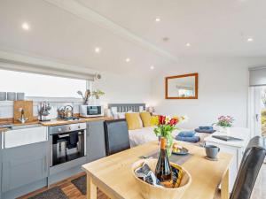 a kitchen and living room with a table and a couch at 1 Bed in Dalry oc-91417 in Dalry