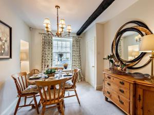 a dining room with a table and a mirror at 3 Bed in Middleham oc-78935 in Middleham