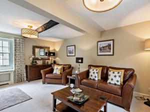 a living room with leather furniture and a table at 3 Bed in Middleham oc-78935 in Middleham