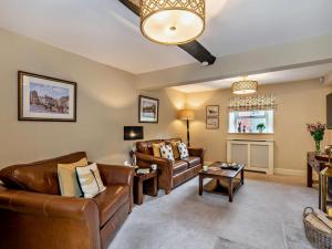 a living room with leather furniture and a fireplace at 3 Bed in Middleham oc-78935 in Middleham