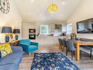 a living room with a blue couch and a table at 3 Bed in Swansea oc-91720 in Killay