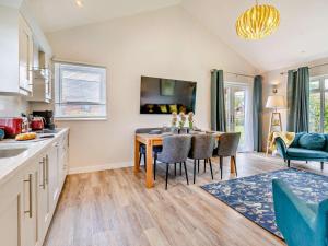 a kitchen and dining room with a table and chairs at 3 Bed in Swansea oc-91720 in Killay +17 photos