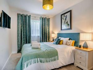 a bedroom with a large bed with green curtains at 3 Bed in Swansea oc-91720 in Killay
