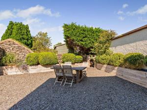 a patio with a table and chairs in a yard at 2 Bed in Cartmel oc-lcc47 in Cartmel