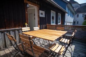 a wooden table and chairs on a deck at Ferienhaus "Zum Lochstein" in Sankt Andreasberg