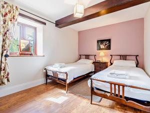 two beds in a room with a window at 2 Bed in Barnard Castle oc-90498 in Middleton in Teesdale
